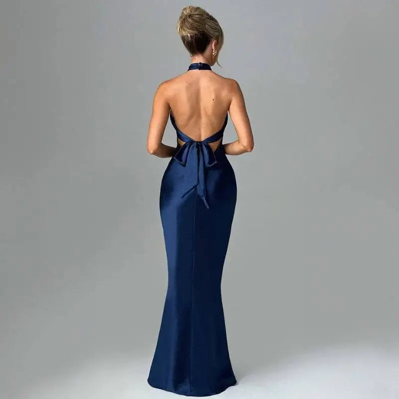 A navy blue elegant backless sleeveless satin mermaid gown with halter neckline and back tie detail