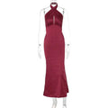 A sleek deep red satin halter neck gown with fitted silhouette showcasing elegant backless sleeveless satin style