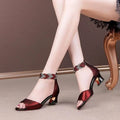 Red metallic block heels with braided ankle strap and silver rhinestones paired with navy blue fish mouth simple rhinestone design