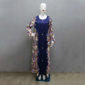 Navy blue floral long sleeved east print dress with solid navy front panel and decorative buttons down the center