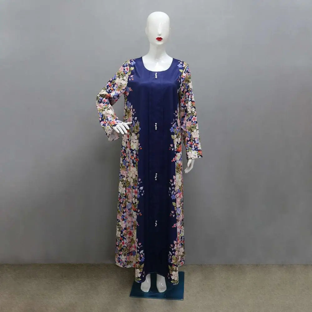 Navy blue floral long sleeved east print dress with solid navy front panel and decorative buttons down the center