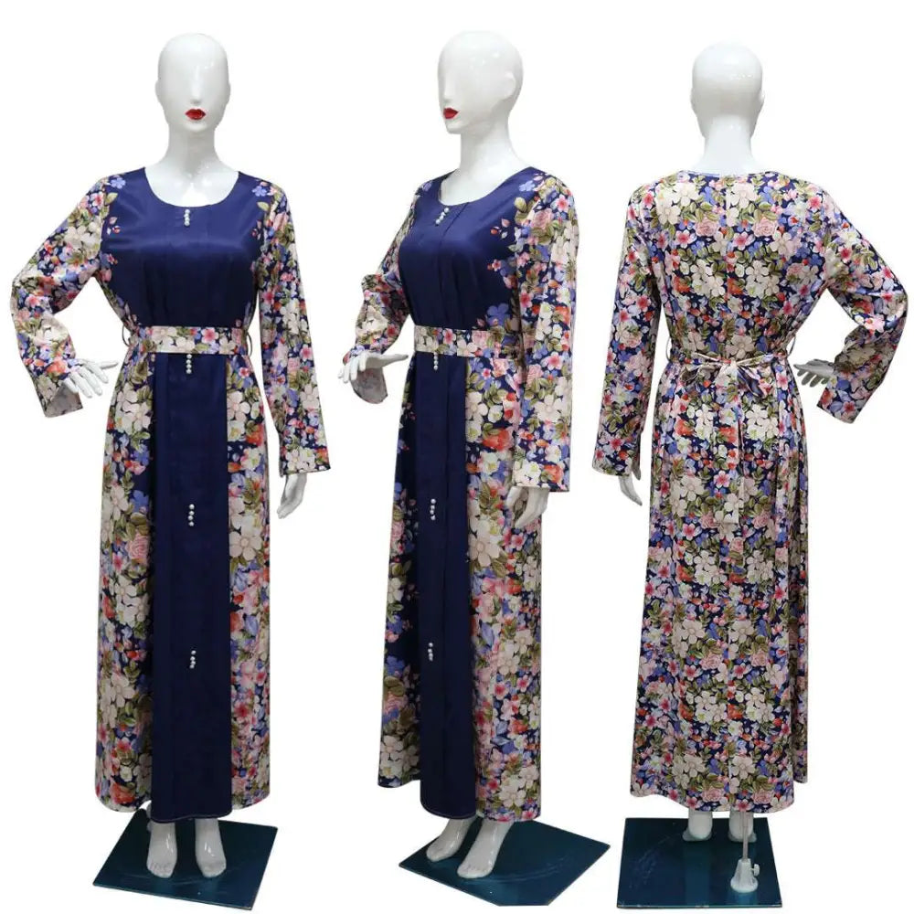 Navy blue floral east print dress with long sleeves, fitted waistband, and delicate beaded details on the front panel