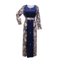A navy blue floral east print dress with long sleeves, fitted waistband, and pearl-like buttons down the front for muslim wear