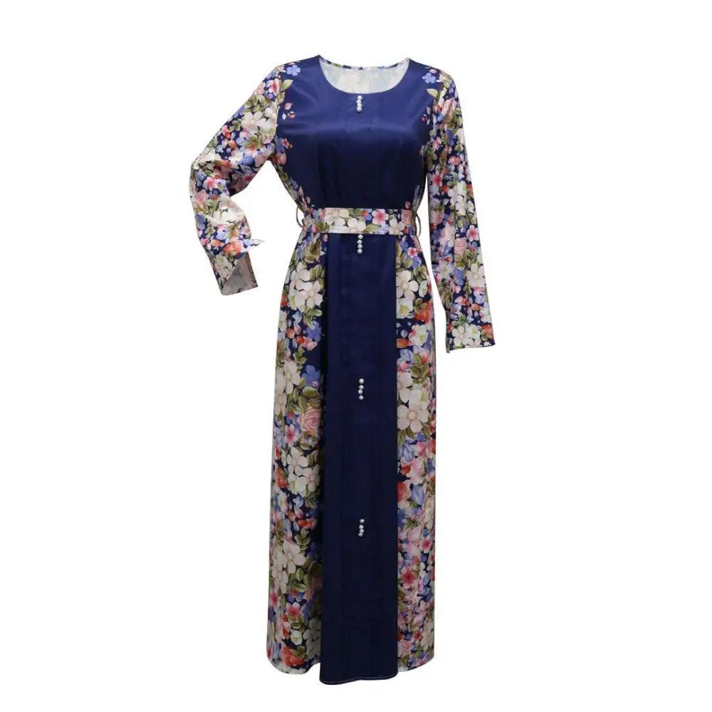 A navy blue floral east print dress with long sleeves, fitted waistband, and pearl-like buttons down the front for muslim wear