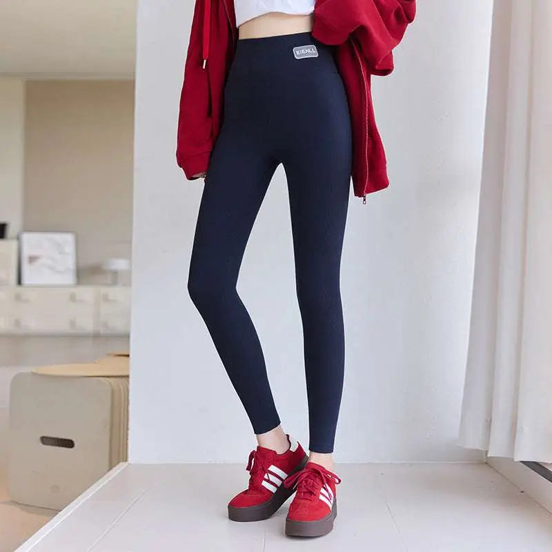 Navy blue high waist elastic threaded underwear leggings with a small white logo patch at the waistband