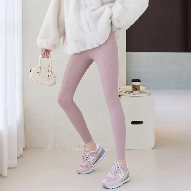 Navy blue high waist elastic threaded underwear leggings styled with soft blush pink ribbed leggings and winter coat