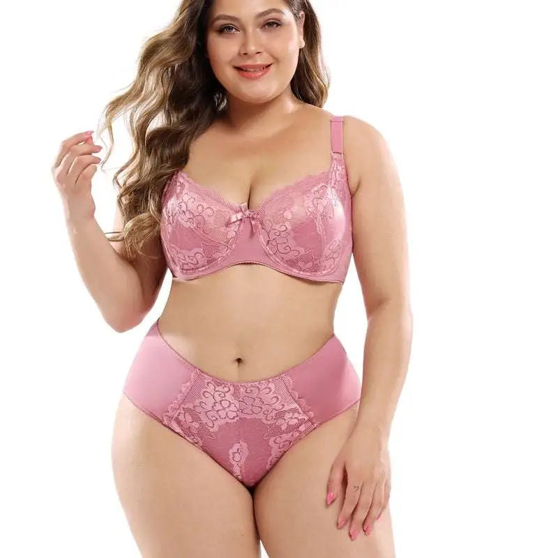 Pink lace plus size bra set with matching high-waisted panties featuring navy blue lace accents