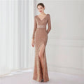Rose gold sequined evening gown with v-neckline long sleeves and high slit for elegant formal occasions
