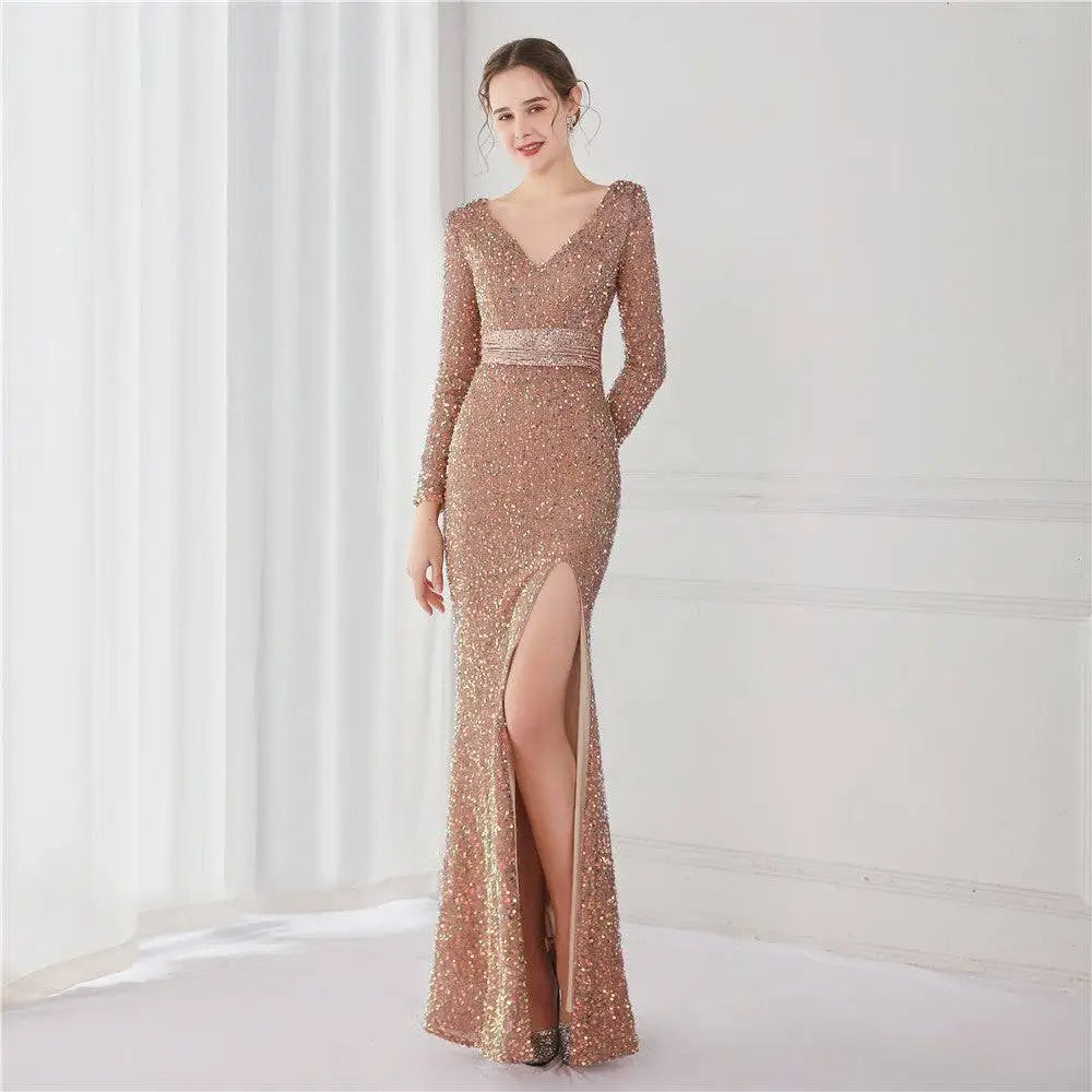 Rose gold sequined evening gown with v-neckline long sleeves and high slit for elegant formal occasions