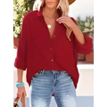 Red button-up blouse with rolled sleeves and relaxed fit styled as navy dropped shoulder bat shirt casual long sleeve