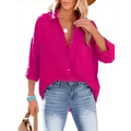 A vibrant fuchsia long-sleeved button-up shirt with rolled cuffs and relaxed fit, contrasting the navy dropped shoulder bat style