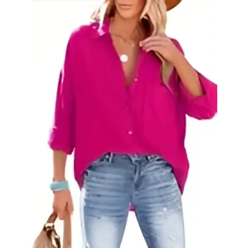 A vibrant fuchsia long-sleeved button-up shirt with rolled cuffs and relaxed fit, contrasting the navy dropped shoulder bat style
