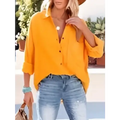 Yellow button-up blouse with rolled sleeves and relaxed fit contrasting the navy dropped shoulder bat shirt long sleeve design