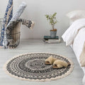 Navy mandala ethnic style round carpet floor mat in black and white with fringed edges and intricate design