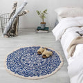 Navy mandala ethnic style round carpet floor mat in blue and white with circular pattern and fringed edges