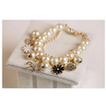Navy pearl flower bracelet featuring cream-colored pearls and a delicate gold horse charm with intricate black flower details