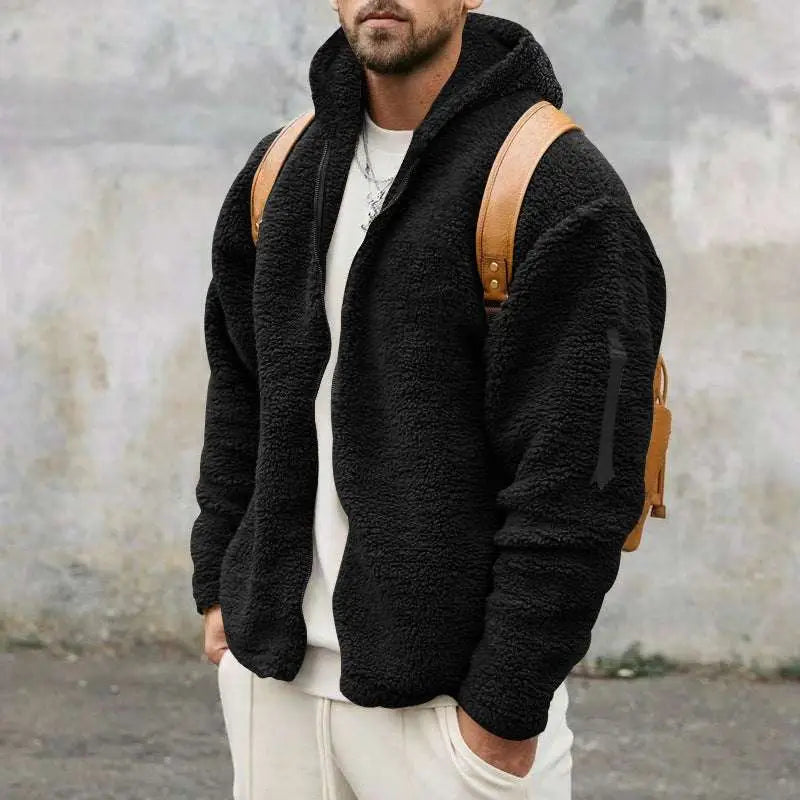 Black plush hooded jacket with fleece lining, textured surface, tan leather shoulder straps, and black zipper detail