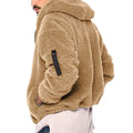 Tan faux fur plush hooded jacket with black patch on sleeve and black zipper for casual wear