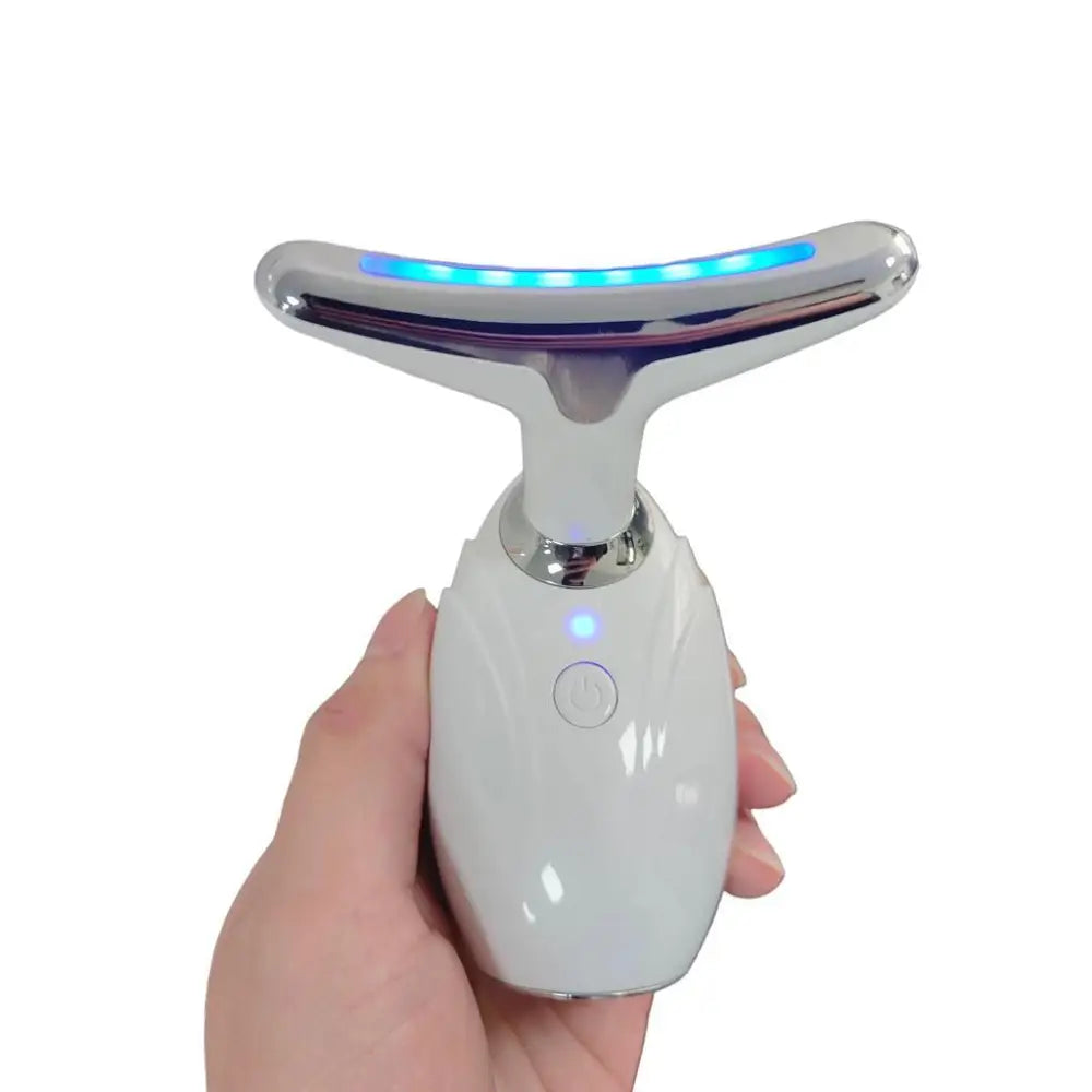 A sleek white and chrome face led device with a glowing blue led strip for reducing double chin and neck wrinkles