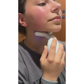 White face led device with smooth handle and silicone head emitting purple light for neck wrinkles and double chin care
