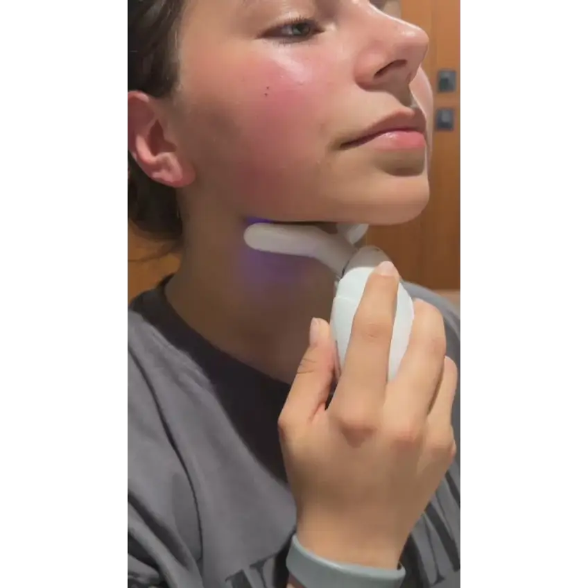 White face led device with smooth handle and silicone head emitting purple light for neck wrinkles and double chin care