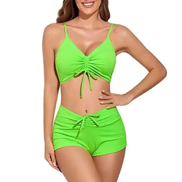 Bright neon green two piece swimsuit featuring a ruched top and matching neon green shorts bikini with front ties