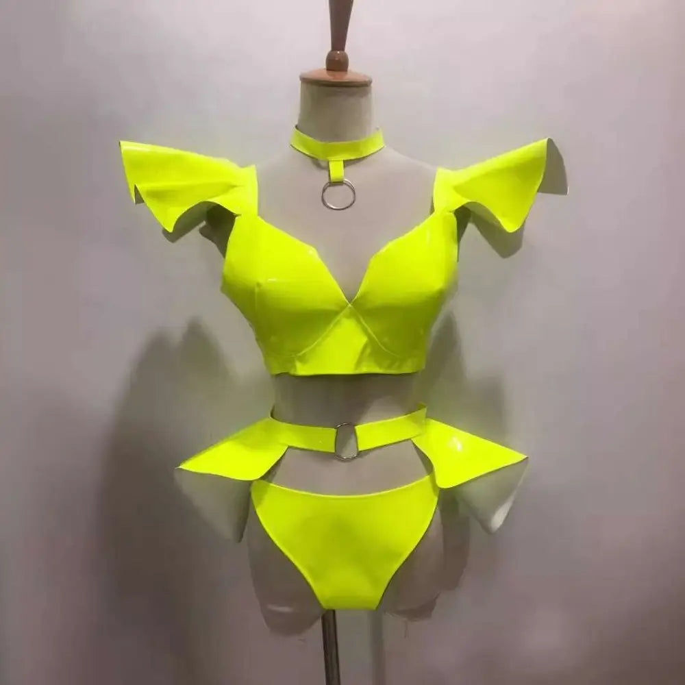 Neon yellow metallic two-piece stage costume with ruffled shoulder straps and matching patent leather belt