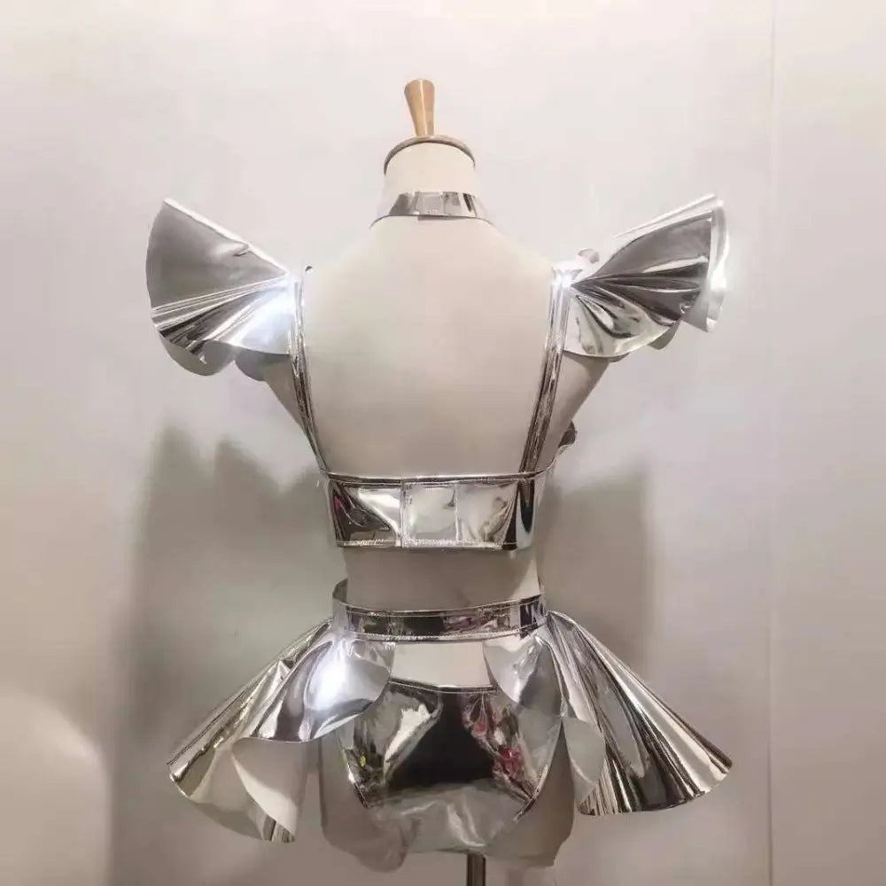 Shiny silver metallic two-piece stage outfit with ruffled shoulder accents and flared skirt for neon yellow costume
