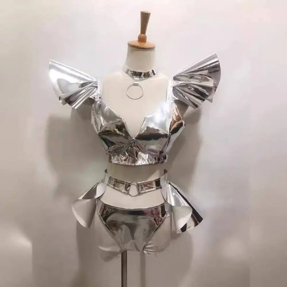 Shiny silver metallic two-piece stage outfit with ruffled shoulder accents and matching belt for neon yellow stage costume