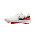 White nike air zoom infinity tour mens golf shoe with black swoosh textured upper and red spiked sole for traction