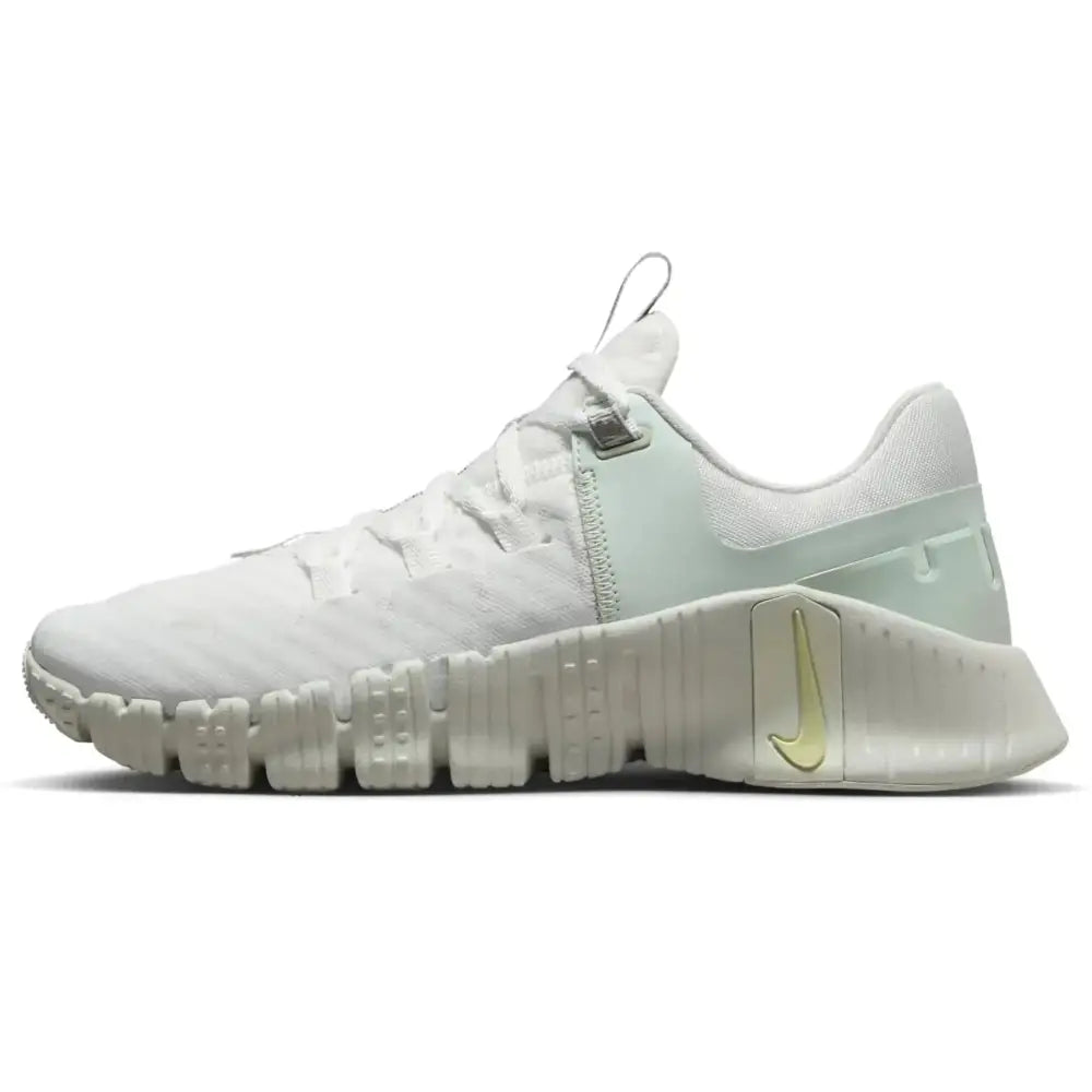 White Nike Free Metcon 5 premium womens training shoes with light mint green accents and yellow swoosh on midsole