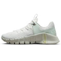 White Nike Free Metcon 5 premium womens training shoes with light mint green accents and yellow midsole swoosh