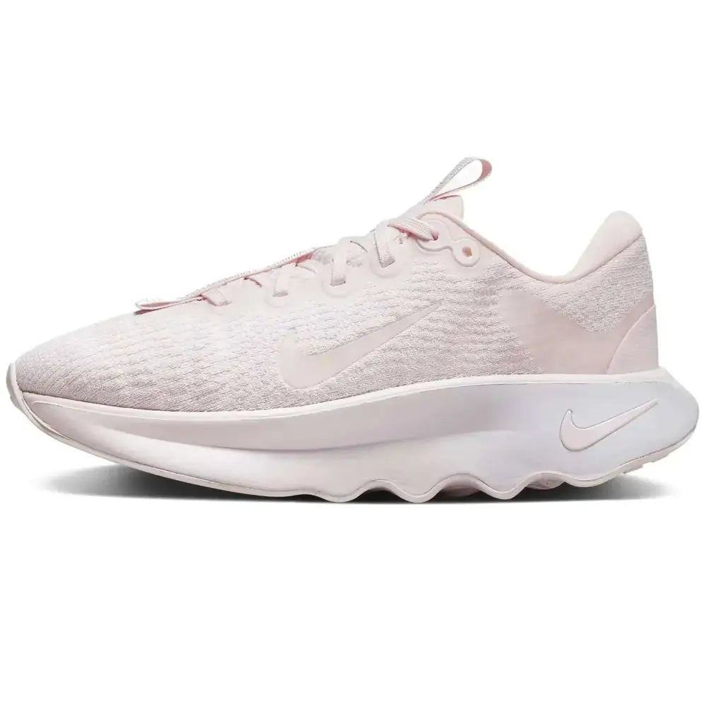 A soft blush pink nike motiva womens walking shoe size 7 with breathable mesh upper and chunky white midsole