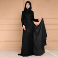 Black sequined maxi dress with long sleeves and flowing sheer overlay in noble elegant slim style for evening wear