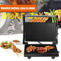 Black nonstick electric grill with ribbed grilling plates and stainless steel handle for steak maker use