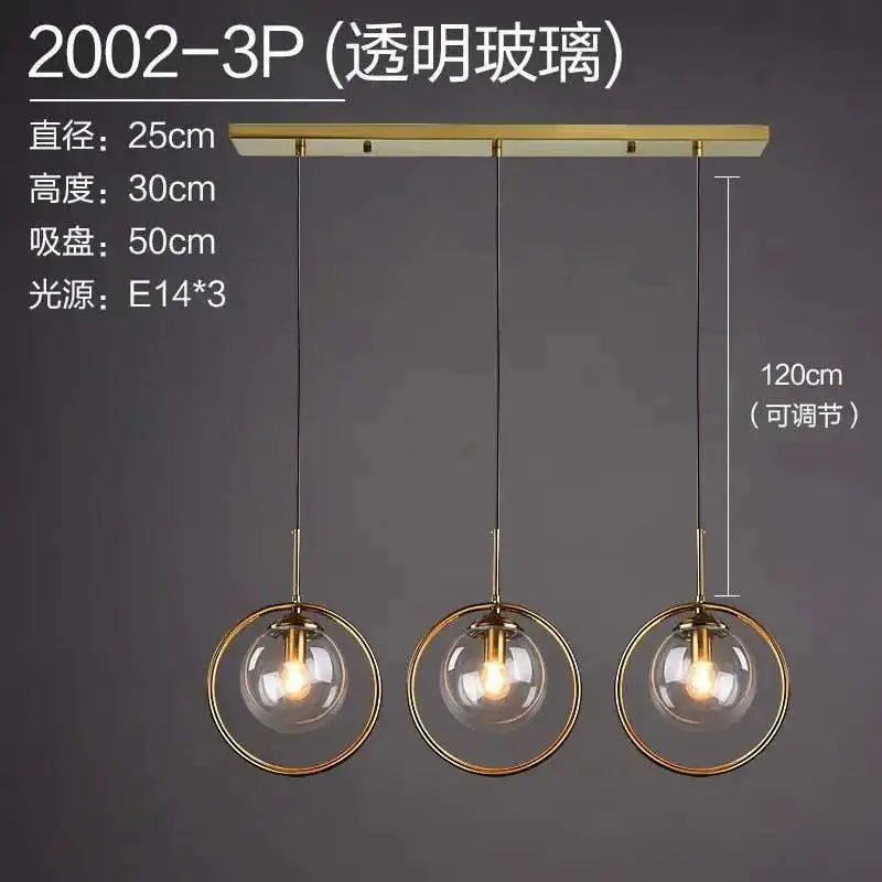 Gold-toned nordic modern minimalist glass pendant light with three transparent spheres suspended from brass bar pendant lamp