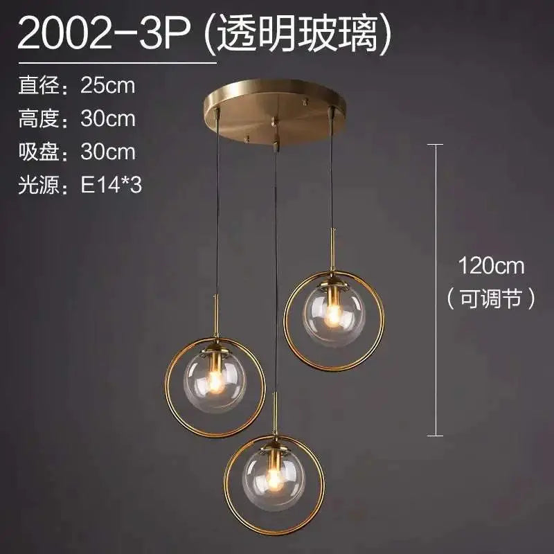 Brass-finished nordic modern minimalist glass pendant light with three transparent globe shades and adjustable cords