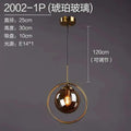 Nordic modern minimalist glass pendant light with spherical amber globe encircled by gold metal ring and brass mount