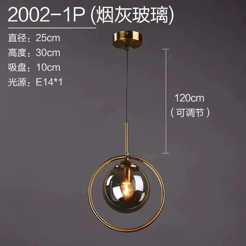 A nordic modern minimalist glass pendant light with a smoked glass globe and gold-toned metal ring on adjustable chain