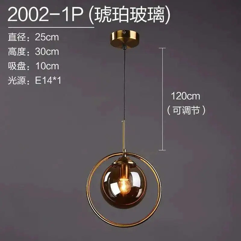 Nordic modern minimalist glass pendant light with amber spherical globe and gold metal ring hanging from brass mount