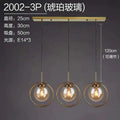 Modern brass-finished nordic modern minimalist glass pendant light with three clear glass globe shades and horizontal bar
