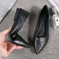 Black leather flat shoes with textured pointed toes paired with nude stiletto toe high heel rhinestone sandals