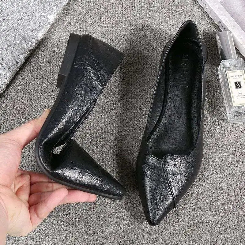 Black leather flat shoes with textured pointed toes paired with nude stiletto toe high heel rhinestone sandals