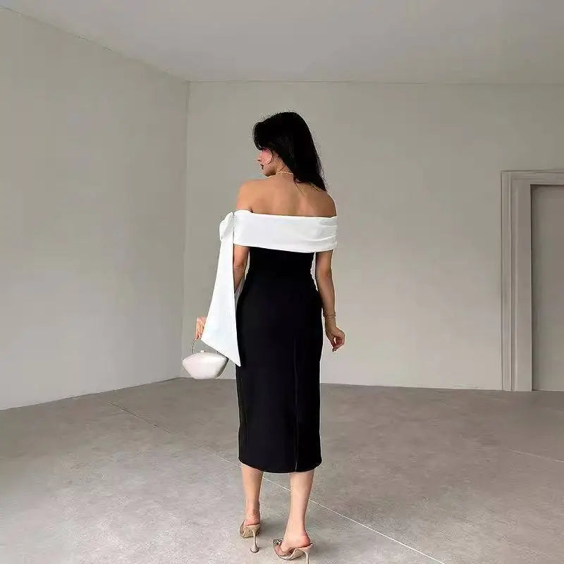 Black off-shoulder color matching elegant cocktail dress with white fabric sash draped over one shoulder