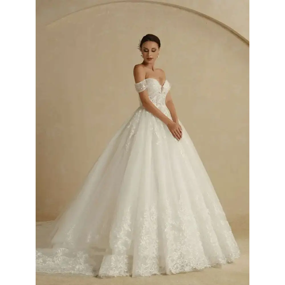 A white off-shoulder lace bridal gown with intricate lace detailing and a voluminous tulle skirt for weddings
