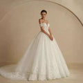White off-shoulder lace bridal gown with intricate lace detailing and voluminous skirt for elegant weddings