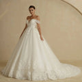 Off-shoulder lace bridal gown in white featuring intricate lace detailing with a fitted bodice and voluminous skirt