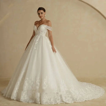 Off-shoulder lace bridal gown in white featuring intricate lace detailing with a fitted bodice and voluminous skirt
