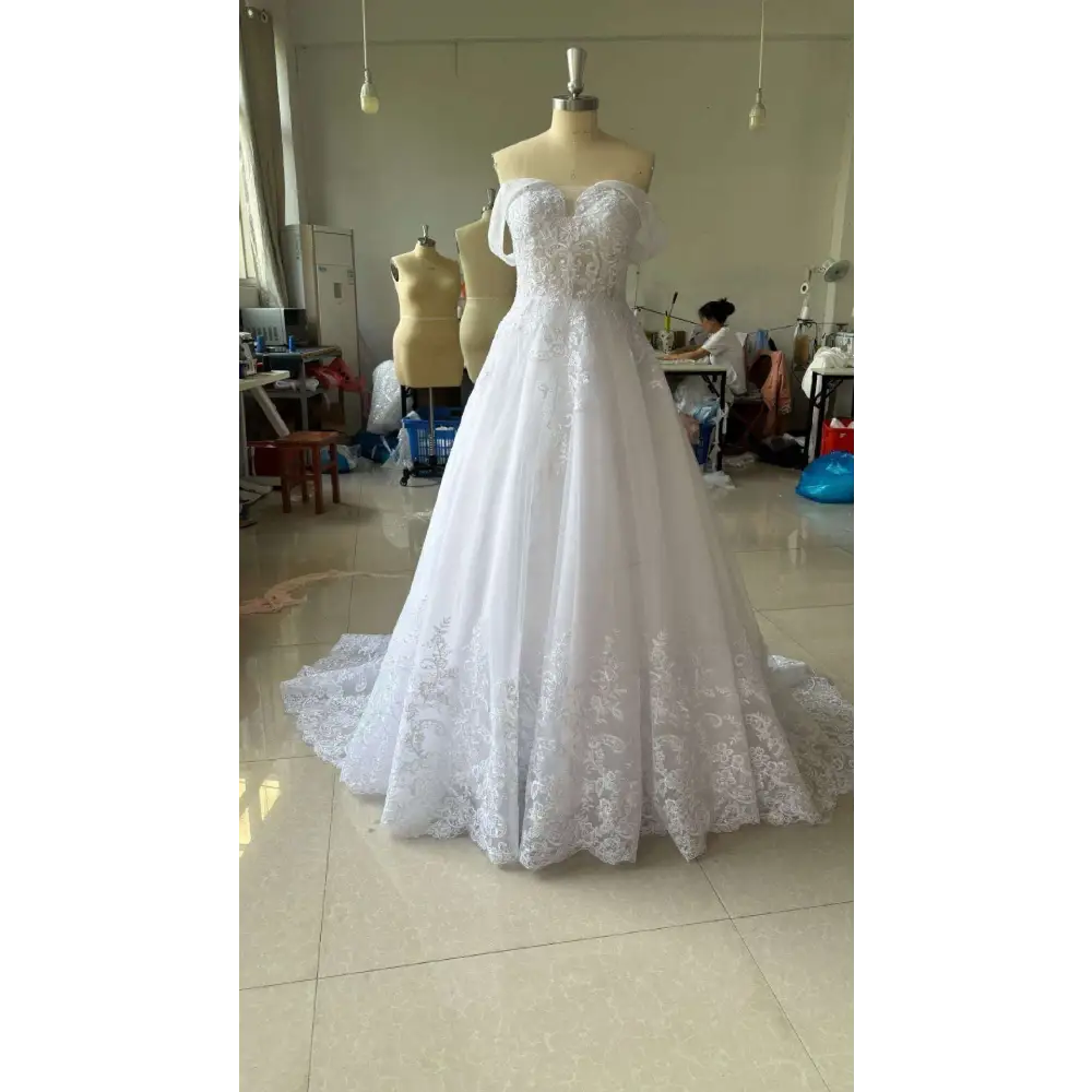 White off-shoulder lace bridal wedding dress with sweetheart neckline and intricate lace detailing on bodice and skirt