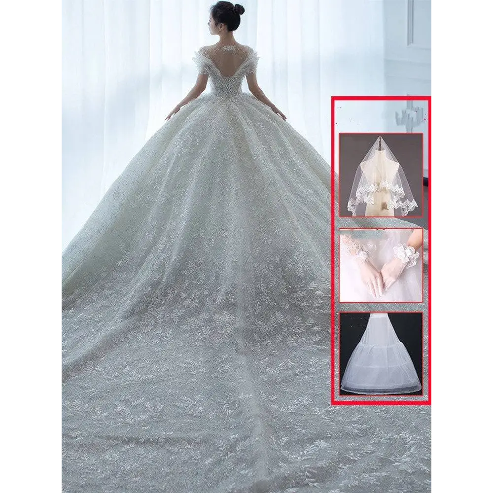 Off shoulder lace wedding dress in white with voluminous skirt and intricate floral embroidery shoulder lace wedding design
